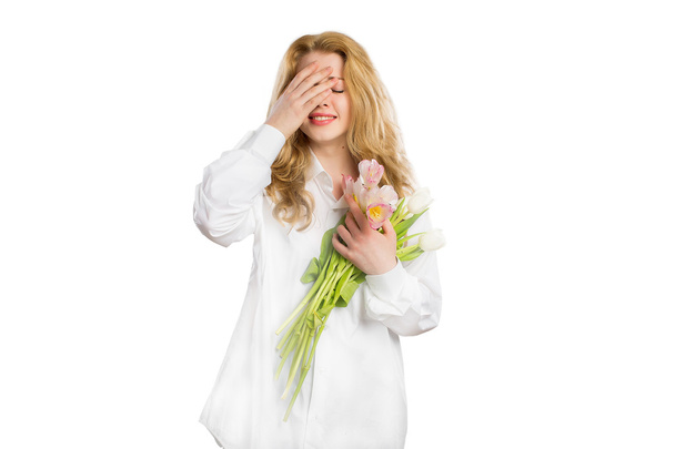  Deeply moved girl with flowers on a white background - Foto, afbeelding