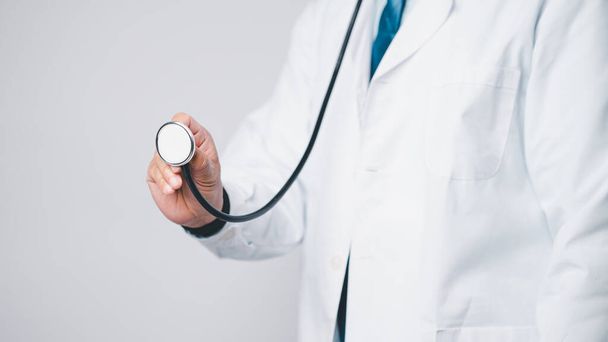 As a medical professional, physician in hospital clinic relied on their stethoscope, extensive knowledge of medicine to provide high-quality health care to their patients. Doctor working in hospital - Photo, Image