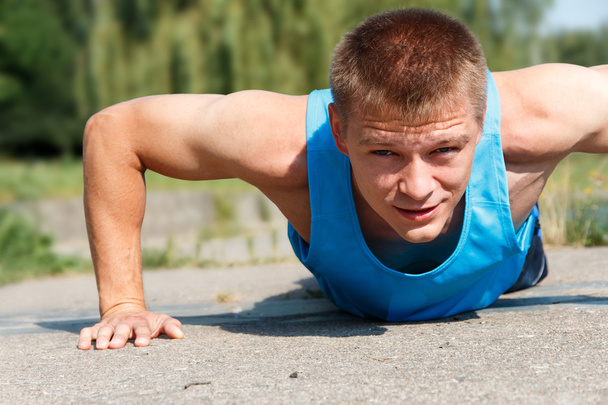 Man doing push-up while outdoor training - Photo, Image