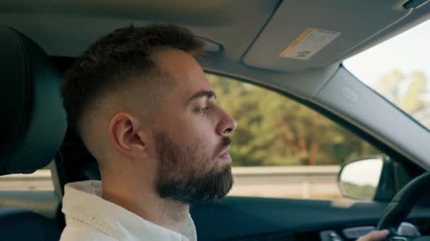 thoughtful serious focused professional driver behind the wheel takes his passenger the car - Footage, Video