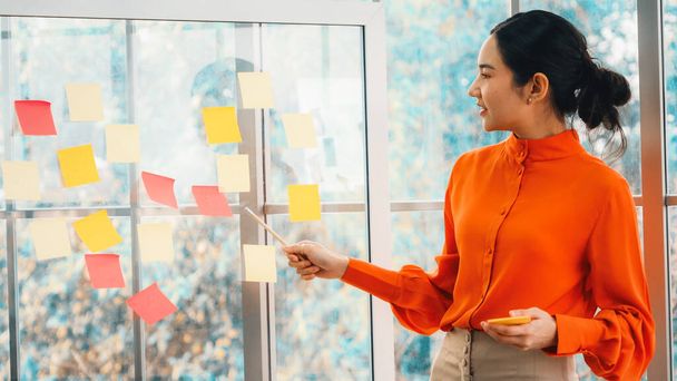 Business people work on project planning board in office and having conversation with coworker friend to analyze project development . They use sticky notes posted on glass to make it organized. Jivy - Photo, Image