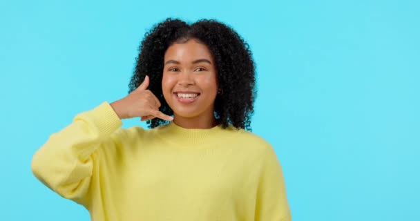 Portrait, woman and hand sign for phone call, contact us or conversation on telephone in blue background for crm mockup. Girl, studio and gesture for cellphone, connection and networking mock up. - Footage, Video