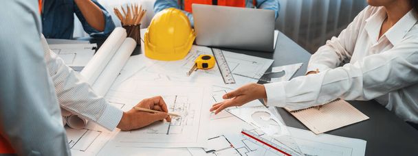 Engineer partner drawing and working on blueprint design together on office table for architectural building construction project. Architect drafting interior blueprint layout. Insight - Photo, Image