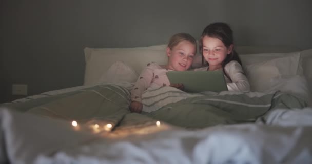 Tablet, night and streaming with children in bedroom for storytelling, digital and watching movies. Happy, internet and technology with kids relax in family home for subscription, online and media. - Footage, Video