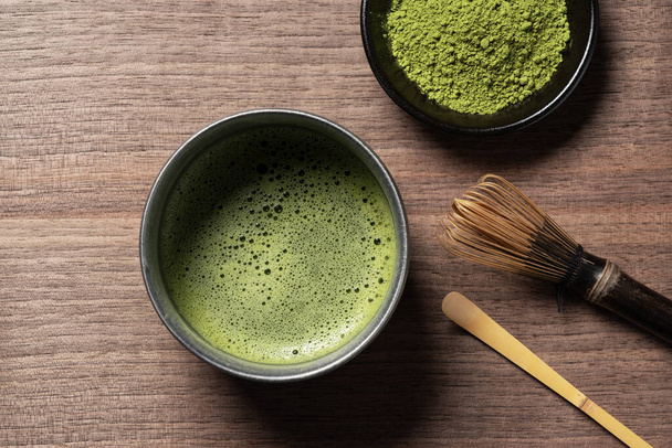 Matcha and matcha powder on a wooden background. View from above. - Photo, Image