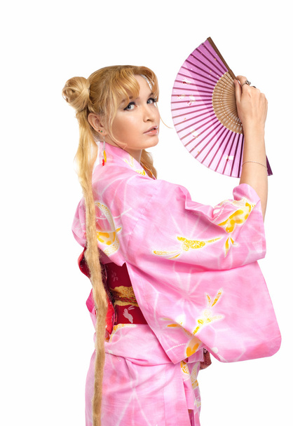 Young woman in kimono costume with fantail - Foto, Bild