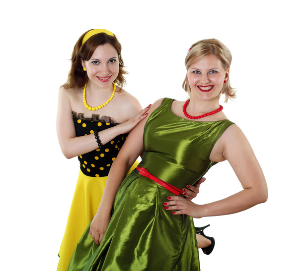 Two young woman in bright colour dresses - 写真・画像