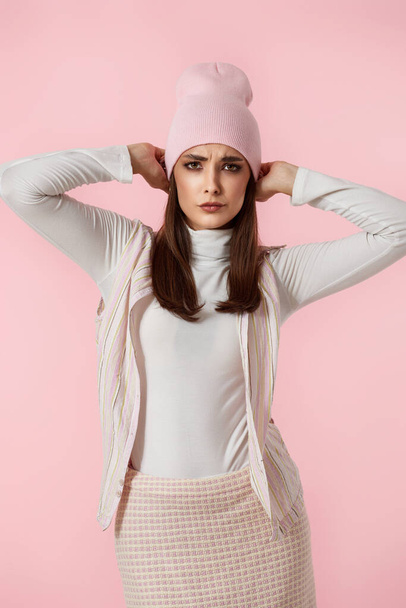 carefree woman in pink hat, shirt and skirt isolated on pastel pink background. - Valokuva, kuva