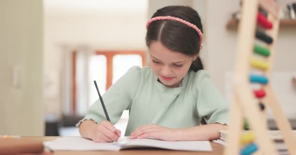 Writing, book and girl child with homework at a table for education and learning. Young school kid or student with a pencil for math or creative project for development with abacus and focus at home. - Footage, Video