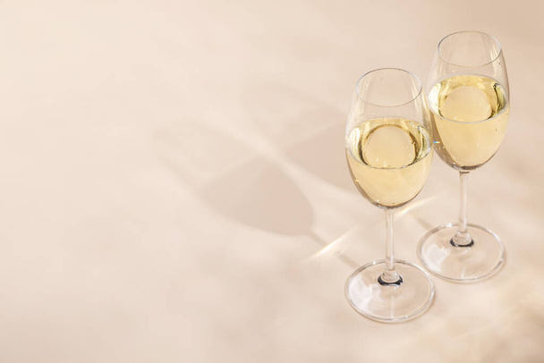 Two champagne glasses on a beige background with copy space - Photo, Image