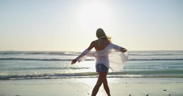 Smile, spinning and woman walking at the beach on holiday, vacation or travel in summer lens flare. Portrait of happy person at ocean, sea and outdoor for freedom, relax or wind in hair in Costa Rica. - Footage, Video