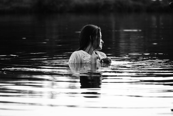czarno-białe zdjęcie dziewczyny nad jeziorem w parku.    - Zdjęcie, obraz