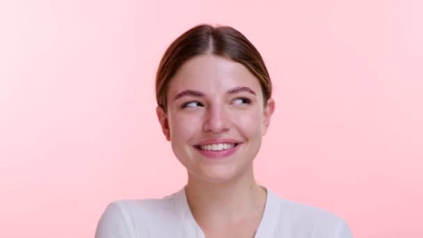 Animated woman playfully smiles directly into the camera, eyes twinkling with mischief and joy. Against the clean pink backdrop, playful demeanor adds a touch of charm. - Footage, Video