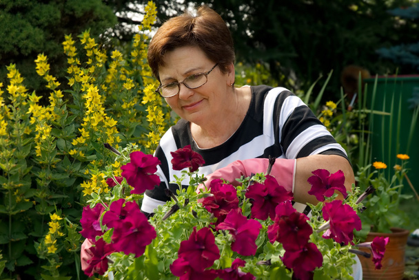 Senior lady in the garden - Фото, изображение