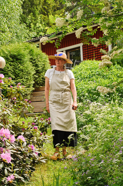 senior woman strolling in garden. - Photo, Image