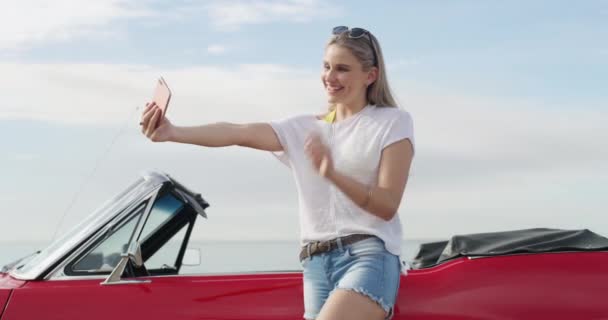 Travel, selfie and woman in a car for road trip, vacation or weekend holiday in the coast. Transport, adventure and young female person from Australia taking a picture with a new luxury vehicle - Footage, Video