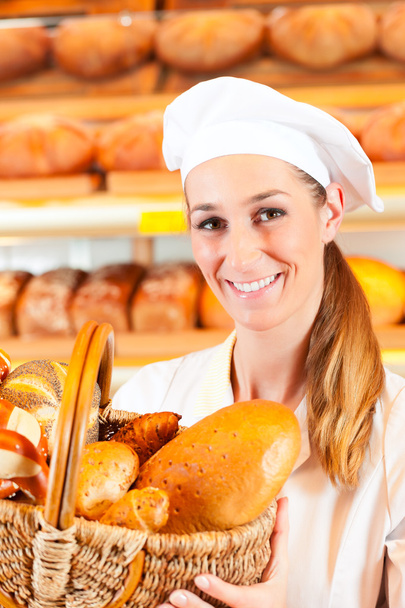 Boulanger féminin vendant du pain
 - Photo, image