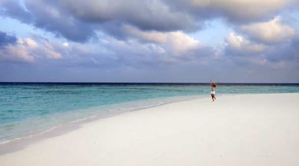 The woman runs on sea coast, Maldives - Photo, Image