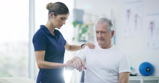 Healthcare, woman physiotherapist and working with senior male patient or doctor help elderly or muscle pain and in the hospital. Medical, female nurse and old man for fitness check or in the clinic. - Footage, Video