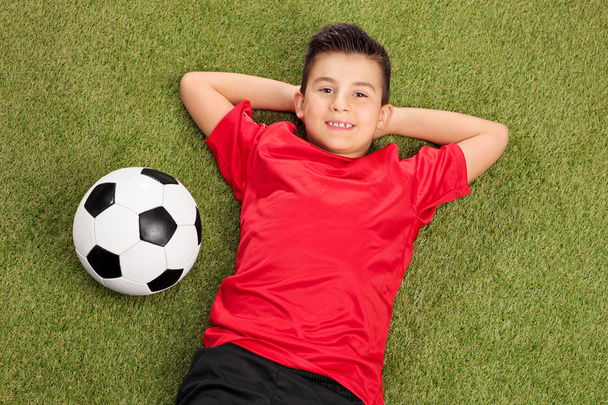 Boy in red football jersey - Фото, изображение