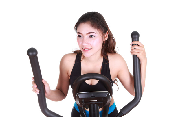 young woman doing exercises with exercise machine - Foto, afbeelding