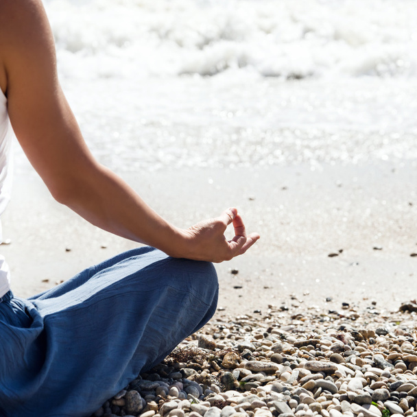 Young woman meditation on the beach - Photo, Image