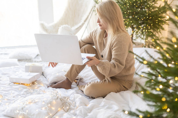 Nuori nainen tilaamalla joululahjoja verkossa. - Valokuva, kuva