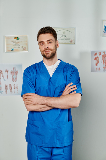 good looking bearded doctor with arms crossed on chest looking straight at camera, healthcare - Photo, Image