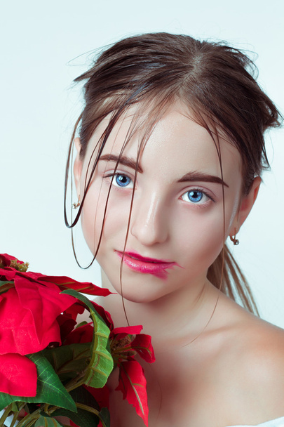 Schönheitsporträt eines jungen Mädchens. Morgenbild mit der Wirkung von feuchtem Gesicht. das Mädchen in den Händen hält eine rote Blume. - Foto, Bild