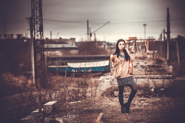 Long hair brunette girl outdoor with old industrial view behind, - Foto, imagen