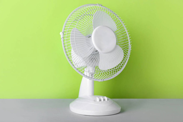 Electric fan on green background - Photo, Image