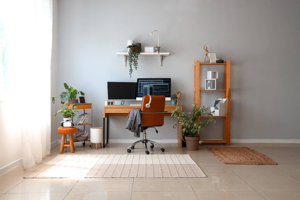 Interior of light office with programmer's workplace and houseplants - Photo, Image