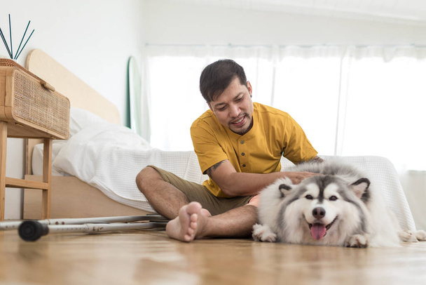 Man with dog in Livingroom at home. Pet being an inspiration while live at home. Lovely pet. Dog and man owner - Foto, imagen