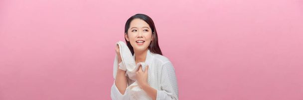 Young woman wiping her face with white towel after waking up in the morning - Photo, Image