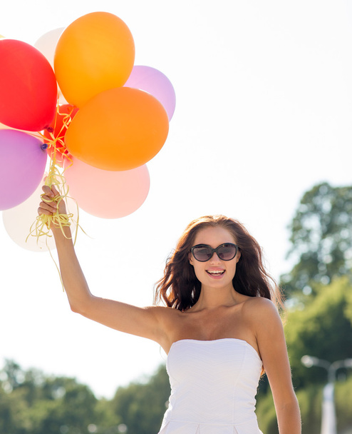 smiling young woman in sunglasses with balloons - Photo, image