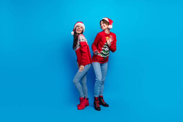 Full length photo of shiny cute women santa elves wear ornament pullovers dancing x-mas event isolated blue color background. - Foto, Imagem