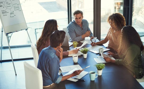 Id like you to lead the task. a group of businesspeople having a meeting in an office - Photo, Image