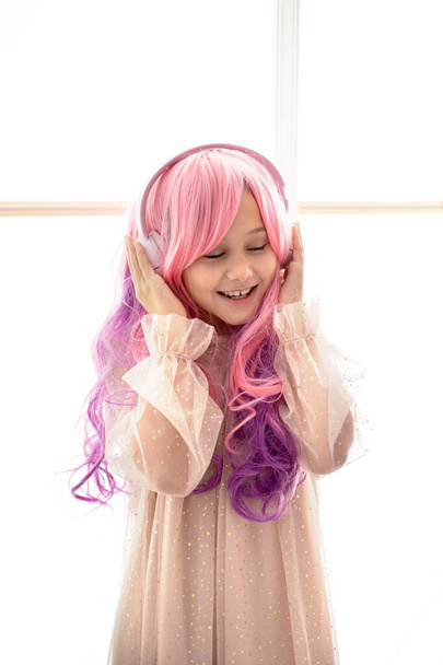 Vanilla Girl. Kawaii vibes. Little girl with pink hair have party in barbie style. Listening music with headphones, mobile phone. - Photo, Image