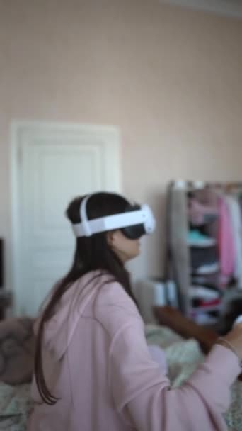 Rózsaszín hálóingében egy elragadó nő videojátékokkal szórakozik egy VR headseten keresztül. Kiváló minőségű 4k felvételek - Felvétel, videó