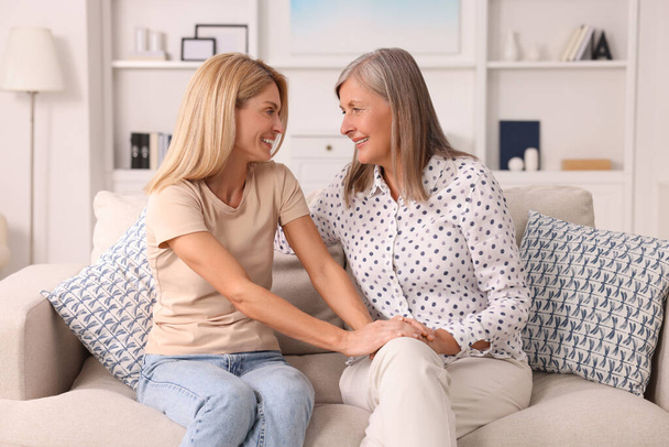Happy mature mother and her daughter spending time together at home - Foto, imagen