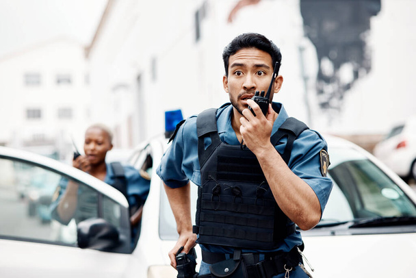 Asian man, police and walkie talkie for suspect in city communication, reinforcement or emergency. Serious male person, security guard or cop radio calling backup for crime in street of an urban town. - Photo, Image