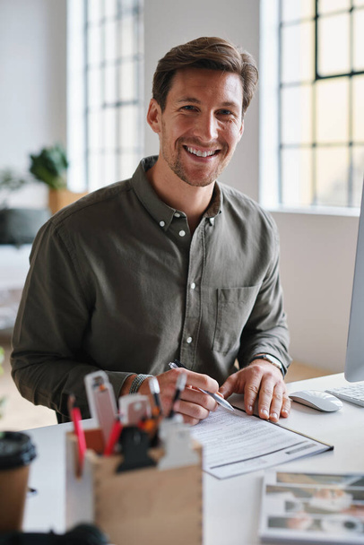 Business man, portrait and contract signing of a worker at an office desk with employee deal. Paperwork, document and planning web worker with b2b agreement feeling happy with work survey and ideas. - Photo, Image