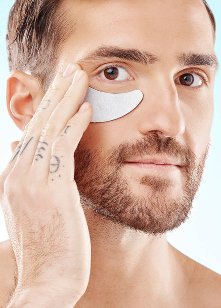 Eye, beauty mask and portrait of a man with dermatology cosmetics with collagen benefits for skin. Aesthetic model person with gel patch for skincare, self care and spa facial for health and wellness. - Foto, Imagem