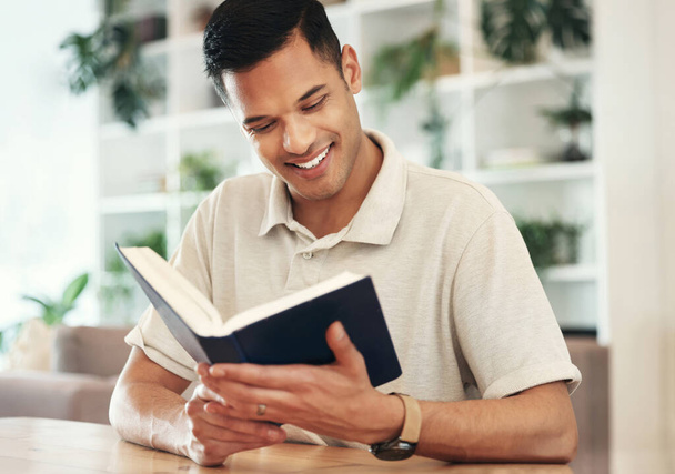 Young man reading bible for religion, faith and god knowledge, studying or research at home. Faith, hope and christian person with holy book for learning, analysis and spiritual wellness or scripture. - Photo, Image