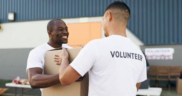 Önkéntes férfiak, segítők és dobozok jótékonysági, élelmiszer és ruhák vezetni a közösségi szolgálat a kedvességért. Csapatmunka, támogatás és társadalmi felelősségvállalás az adományozási csomagért, mosoly és gondozás a műhelyben. - Fotó, kép