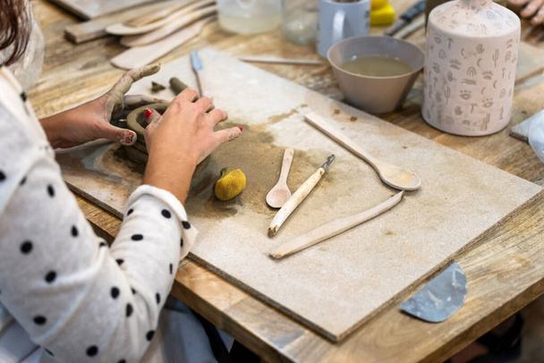 Ceramic works. Shaping clay on a work table. - Photo, Image