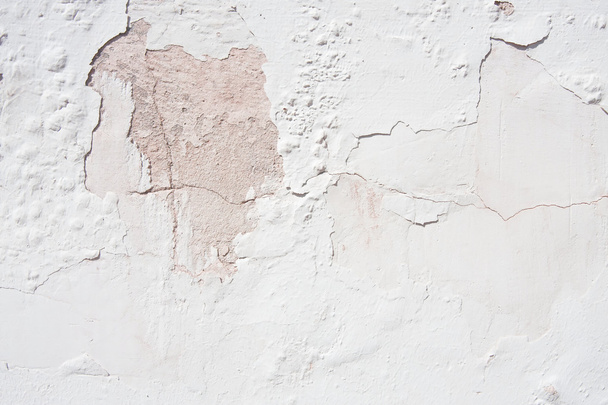 Cracked plaster over pink stone - Photo, Image