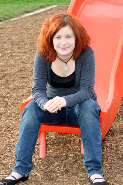 Hymyilevä teini istuu liukuva aluksella
 - Valokuva, kuva