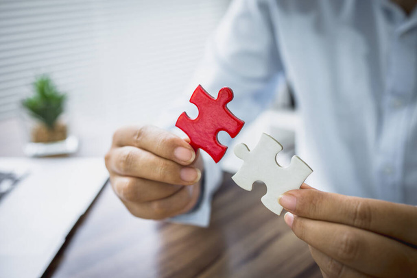person hand connecting jigsaw puzzle, Business solutions, target, success, goals and strategy concepts,  teamwork idea. - Photo, Image