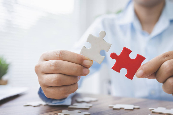 person hand connecting jigsaw puzzle pieces, business solutions, goals, success, goals and strategy concept, teamwork concept. - Photo, Image